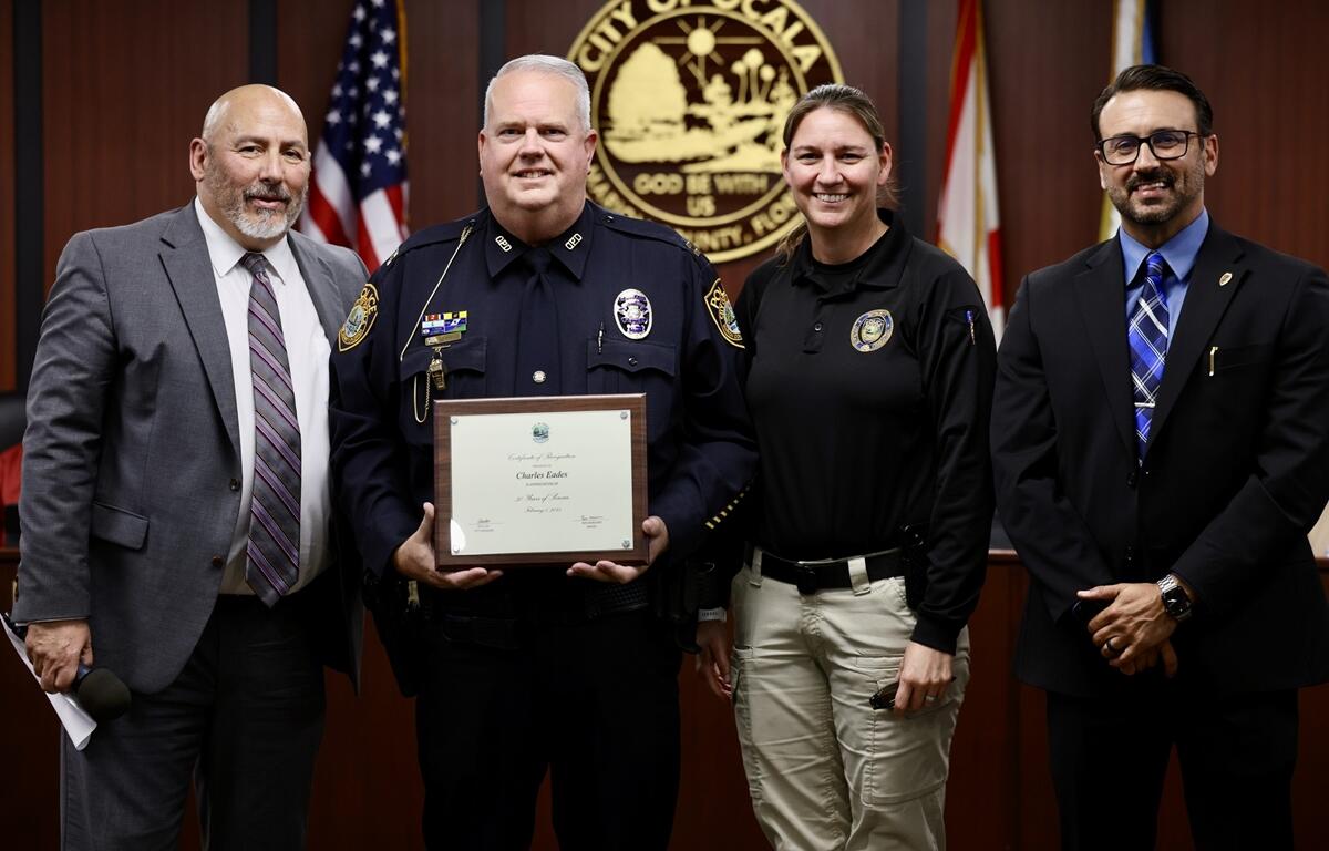 Ocala Police Capt. Charlie Eades receives a certificate recognizing his 30 years of service during Tuesday night's City Council meeting.