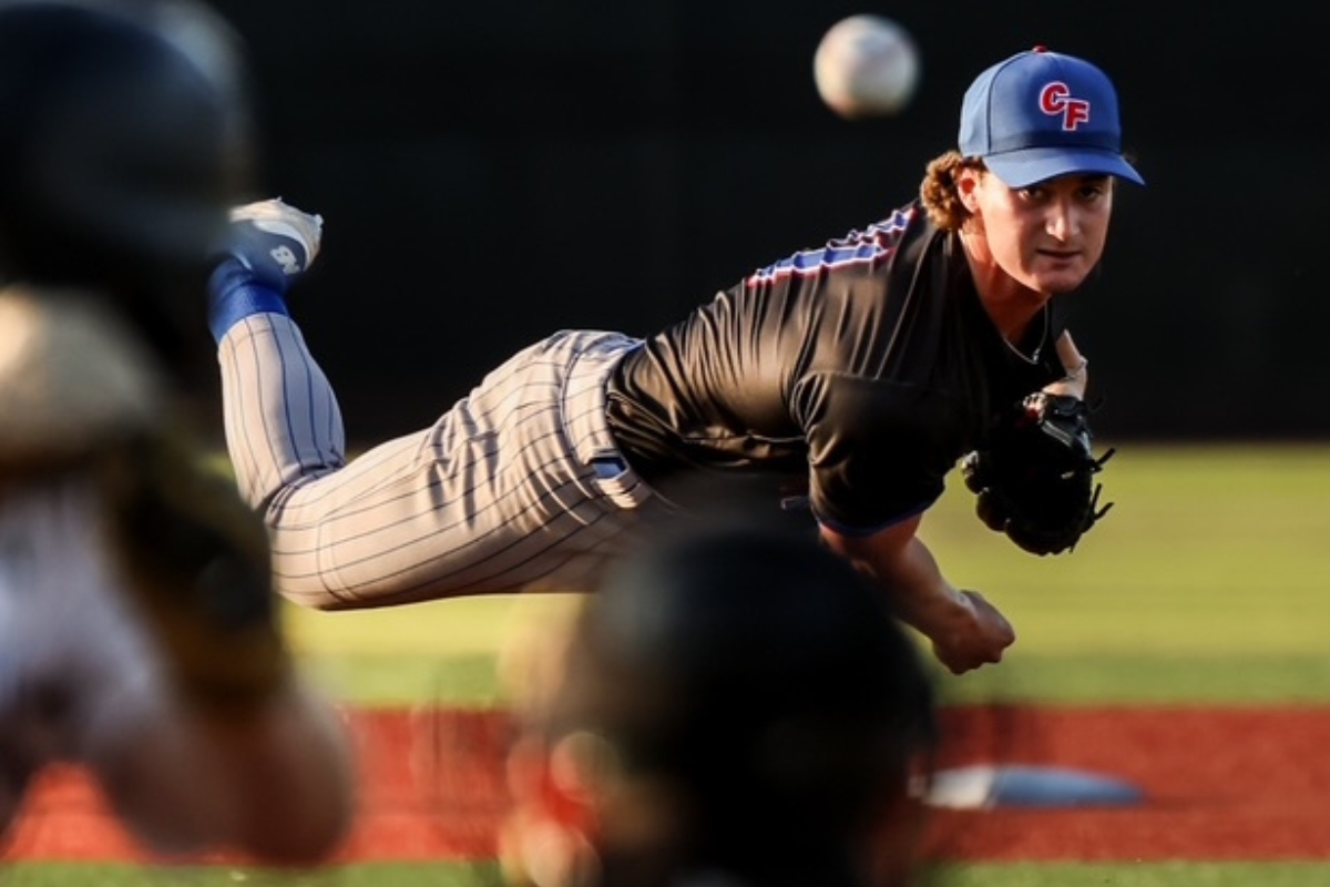 College of Central Florida pitcher Brayden Toro mid-throw, captured in midair with intense focus during a game, as the ball approaches the batter.