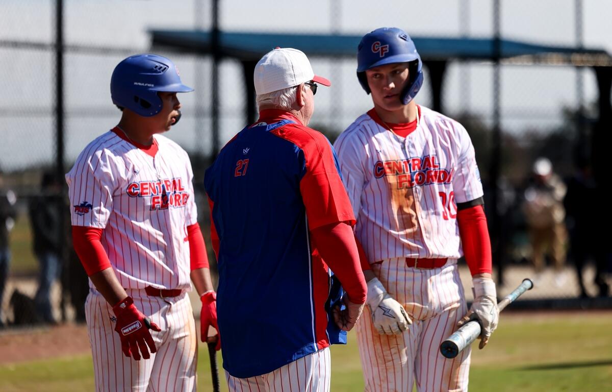 Central Florida head coach Marty Smith talks with his players on the field during a game against Miami-Dade College on Saturday, Feb. 17, 2025, in Miami. The Patriots secured a 6-5 win in the second game of the doubleheader to split the series.