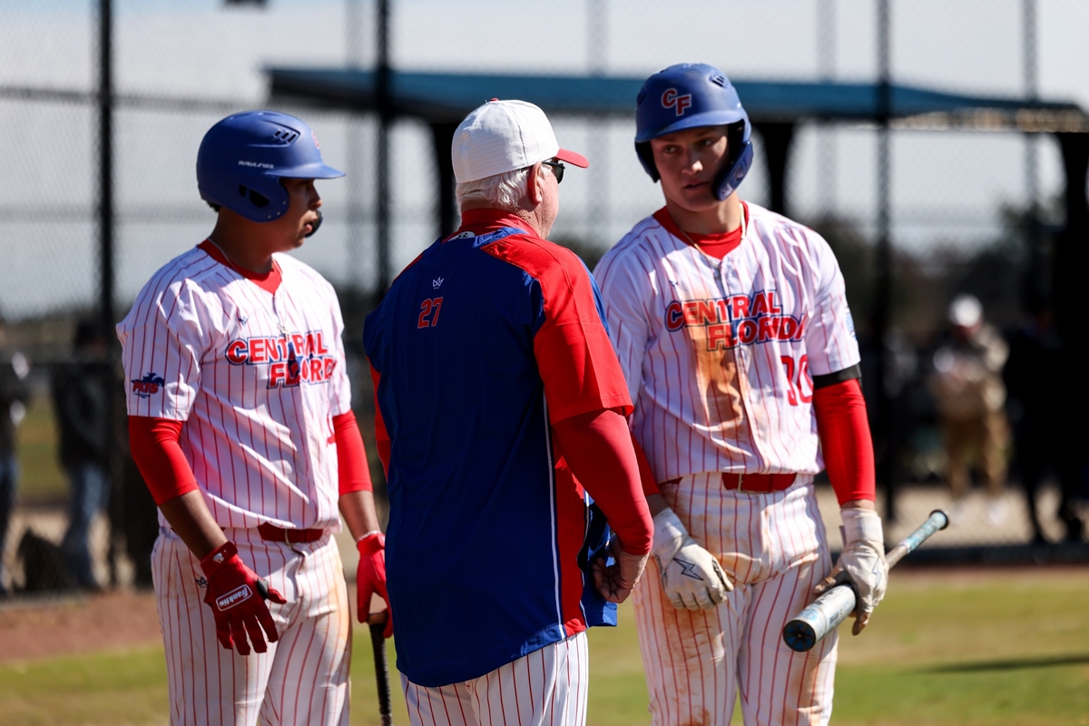 Central Florida head coach Marty Smith talks with his players on the field during a game against Miami-Dade College on Saturday, Feb. 17, 2025, in Miami. The Patriots secured a 6-5 win in the second game of the doubleheader to split the series.
