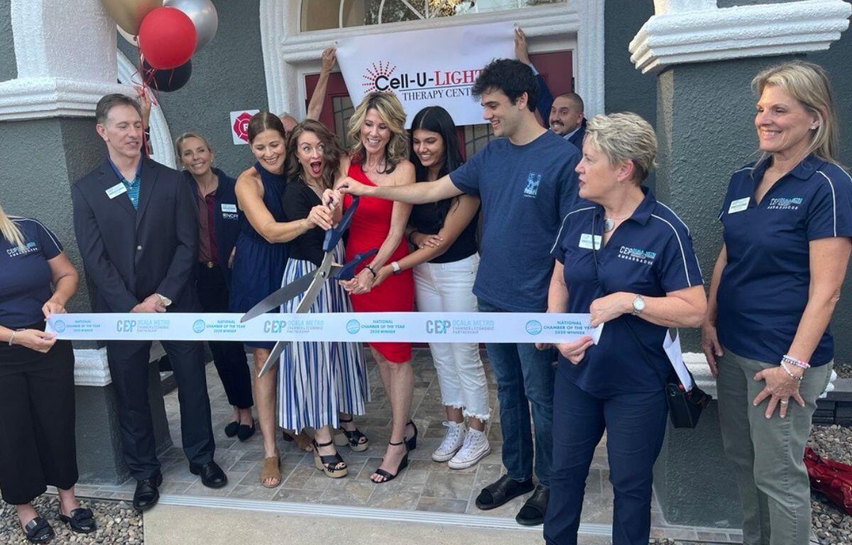 Dr. Angelia Roberts Reddy, joined by family, friends, and Ocala Metro CEP representatives, cuts the ribbon at the grand opening of Cell-U-Light Therapy Center in Ocala, Fla., on Feb. 12, 2025. The new facility offers a variety of wellness therapies, including red light therapy and cellulite treatment.