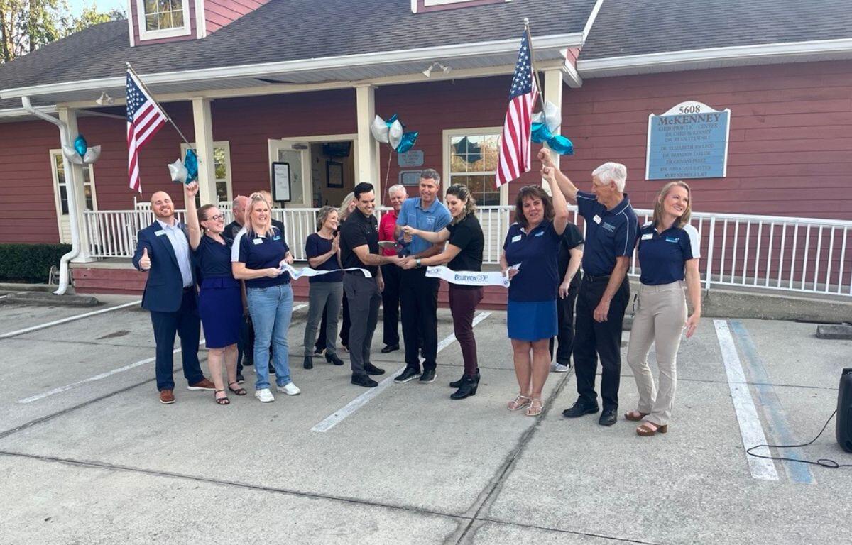 Members of the Belleview Chamber and Economic Partnership hold a ribbon-cutting ceremony on Feb. 4, 2025, to welcome two new doctors to McKenney Chiropractic Center in Belleview, FL.