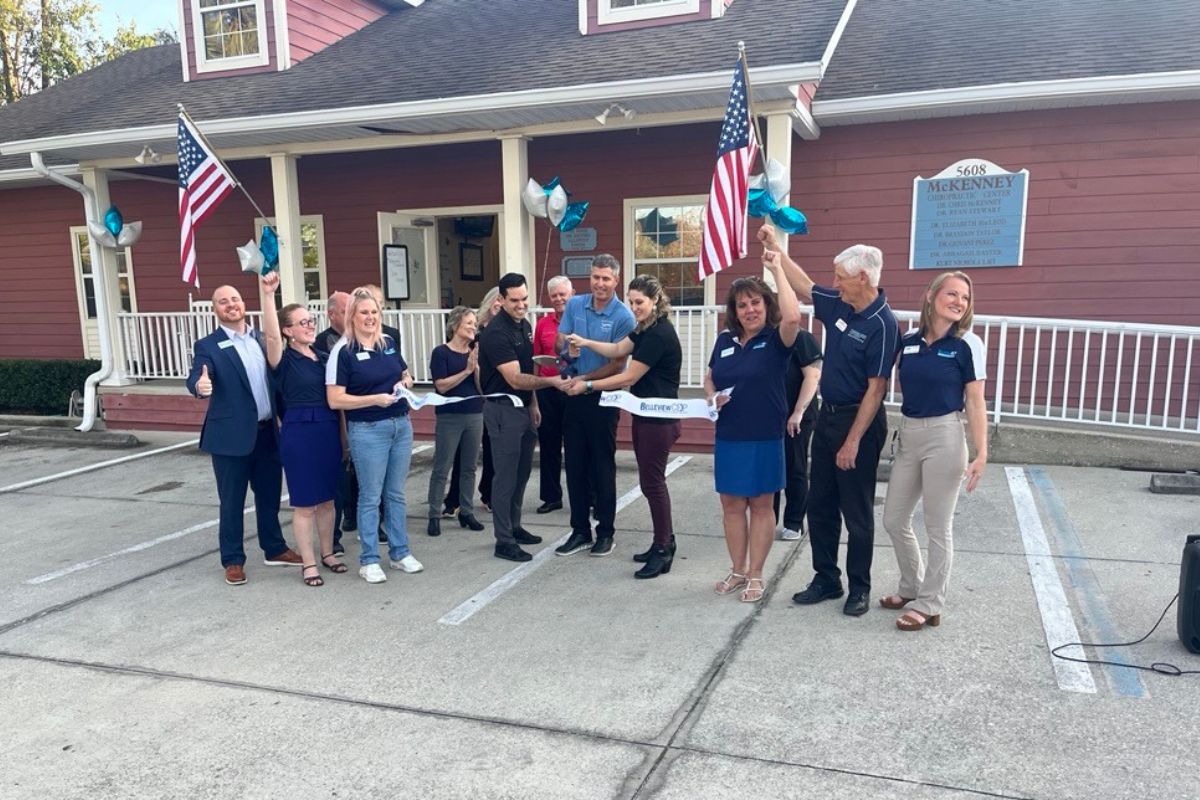 Members of the Belleview Chamber and Economic Partnership hold a ribbon-cutting ceremony on Feb. 4, 2025, to welcome two new doctors to McKenney Chiropractic Center in Belleview, FL.