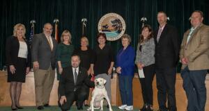 Molly, center, poses with Marion County Commissioners along with SPCA of Ocala Board Members. Courtesy: SPCA of Ocala