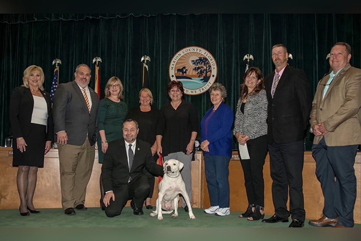Molly, center, poses with Marion County Commissioners along with SPCA of Ocala Board Members. Courtesy: SPCA of Ocala