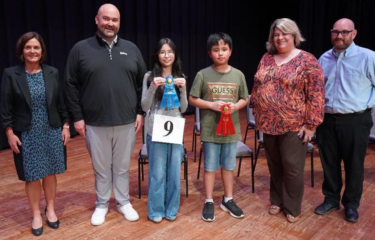 2025 Marion County Spelling Bee Champion Ava Mai and Runner-Up Elias Javelona (both center) pose with (from left) MCPS’s Dr. Danielle Brewer, Liberty Middle Principal Reuben “Bo” Williams, Howard Middle Principal Suzette Parker, and Spelling Bee Director Mark Ingram after the competition at Marion Technical Institute in Ocala, Fla., on Tuesday.