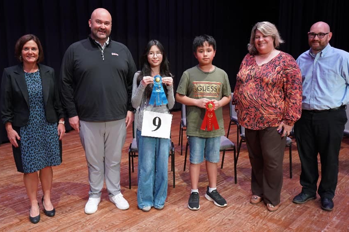 2025 Marion County Spelling Bee Champion Ava Mai and Runner-Up Elias Javelona (both center) pose with (from left) MCPS’s Dr. Danielle Brewer, Liberty Middle Principal Reuben “Bo” Williams, Howard Middle Principal Suzette Parker, and Spelling Bee Director Mark Ingram after the competition at Marion Technical Institute in Ocala, Fla., on Tuesday.