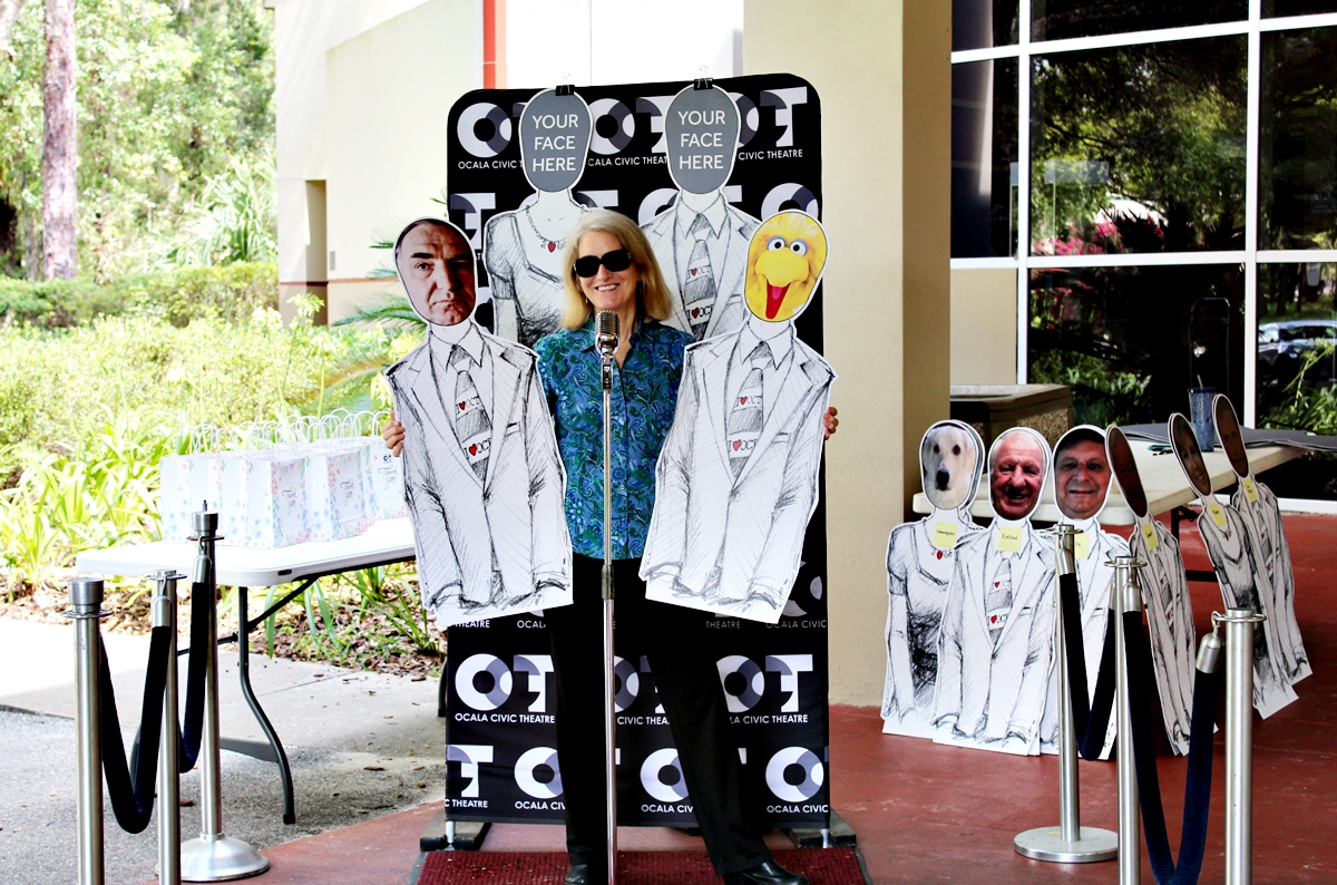 WUFT's community partnership display features cutouts of the PBS characters Carson the Butler from Downton Abbey and Big Bird from Sesame Street. These cutouts acted as audience fillers during the pandemic.