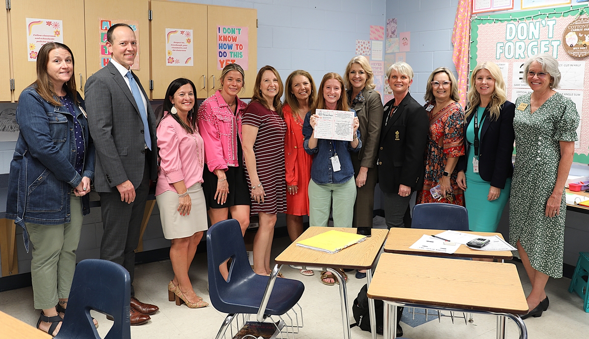 Pictured from left to right are: Vanguard High School Assistant Principal Samantha Roberts; HCA Florida Ocala Hospital CEO Alan Keesee; Public Education Foundation of Marion County board member Melissa Conner; Marion County School Board member Sarah James; Golden Apple Academy member Beth Abel; School Board Chairwoman Lori Conrad; Thank a Teacher recipient Claire Sensibaugh; Marion County Public Schools Superintendent Diane Gullett; Golden Apple Academy Chairwoman Emily Cook; Vanguard High School Principal Colleen Wade; Public Education Foundation of Marion County Executive Director Meghan Magamoll; and School Board member Nancy Thrower.