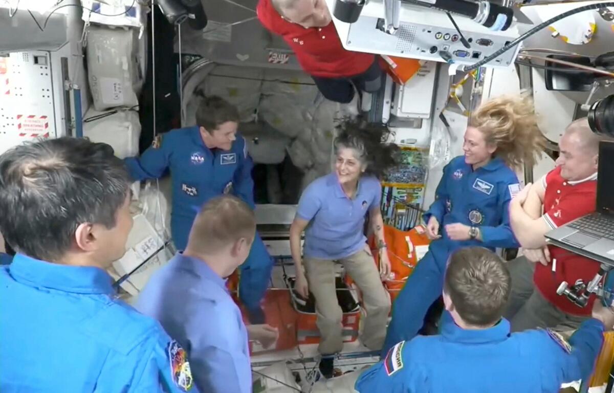 This image made from video by NASA shows astronauts, including Suni Williams, center, greeting each other after a SpaceX capsule docked with the International Space Station, Sunday, March 16, 2025. NASA via AP