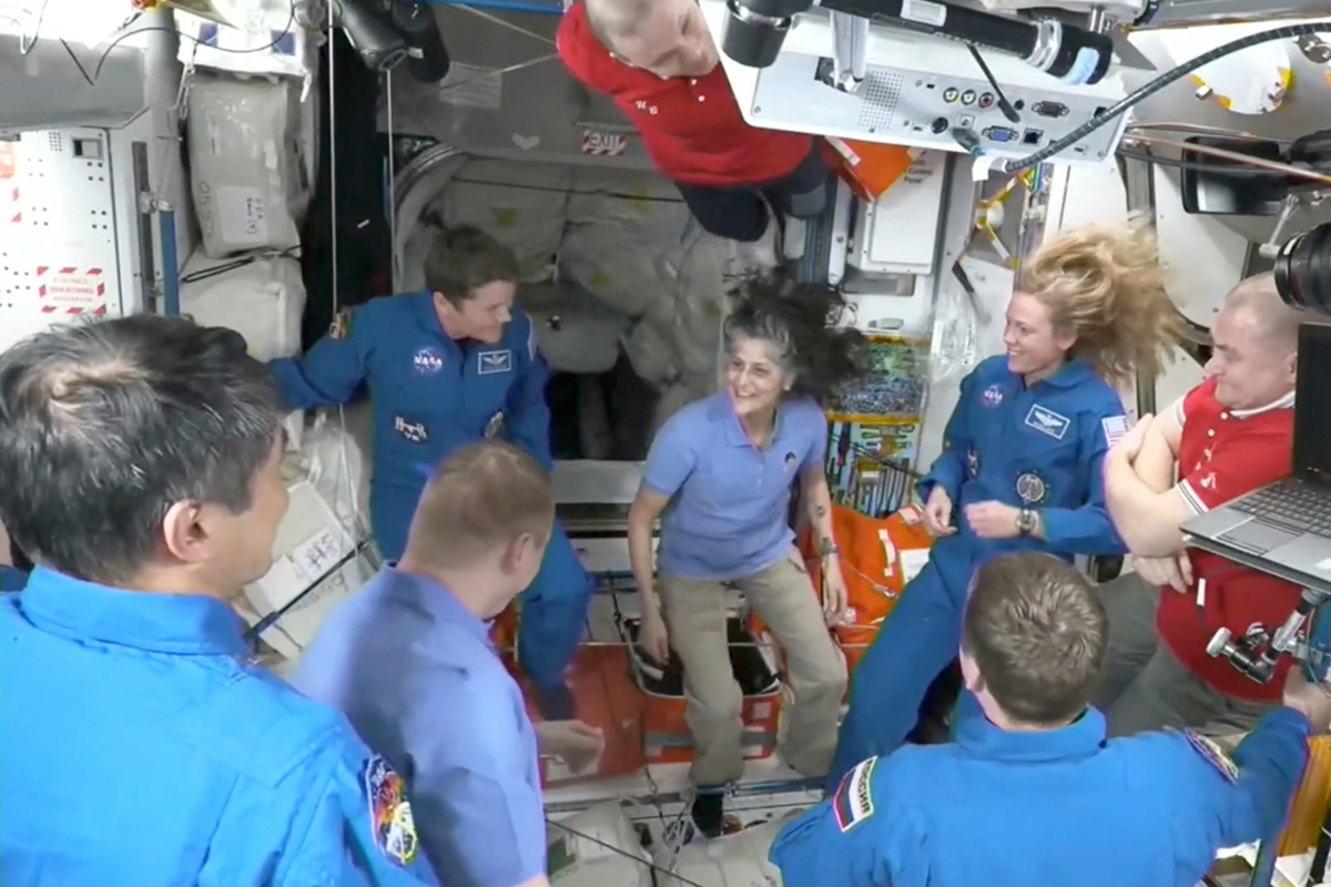 This image made from video by NASA shows astronauts, including Suni Williams, center, greeting each other after a SpaceX capsule docked with the International Space Station, Sunday, March 16, 2025. NASA via AP