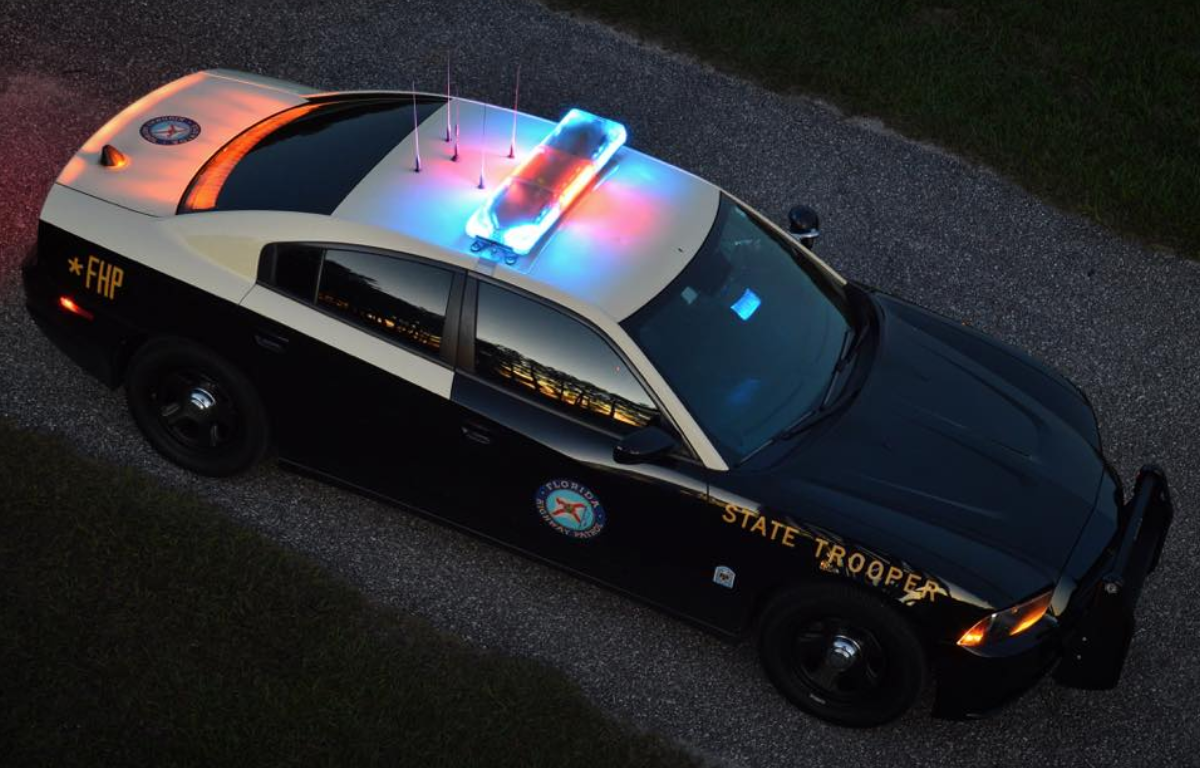 Florida Highway Patrol cruiser with red and blue lights on