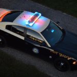 Florida Highway Patrol cruiser with red and blue lights on