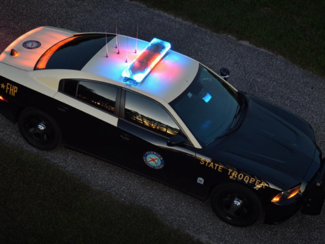 Florida Highway Patrol cruiser with red and blue lights on