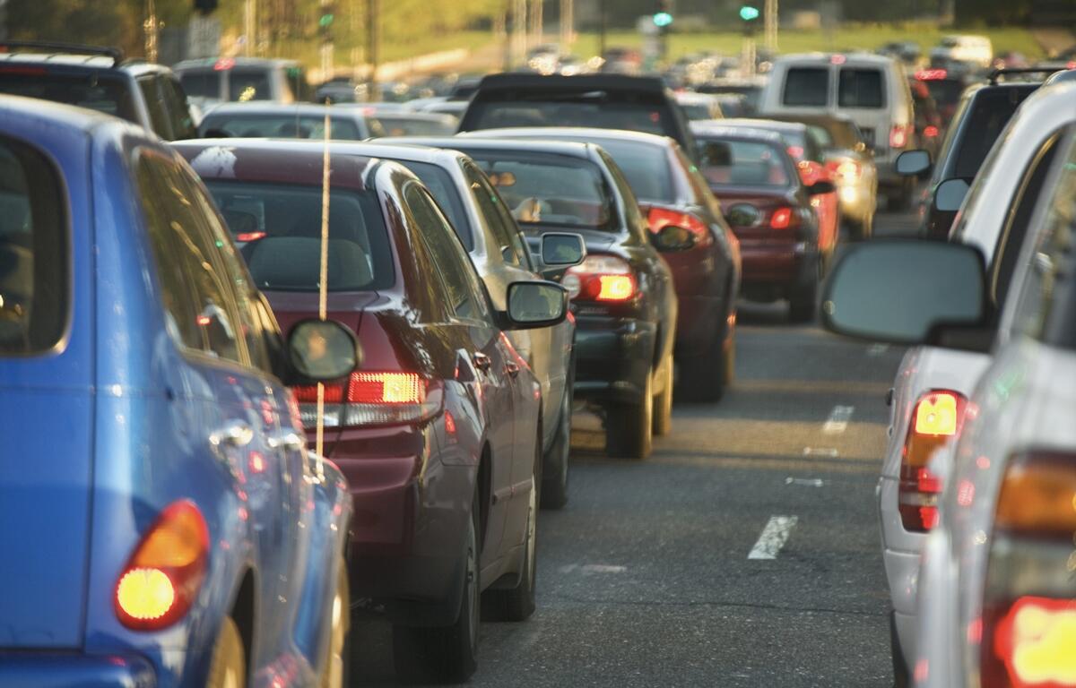 Heavy highway traffic with multiple lanes of vehicles during daytime travel.