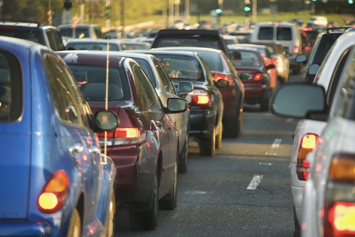 Heavy highway traffic with multiple lanes of vehicles during daytime travel.