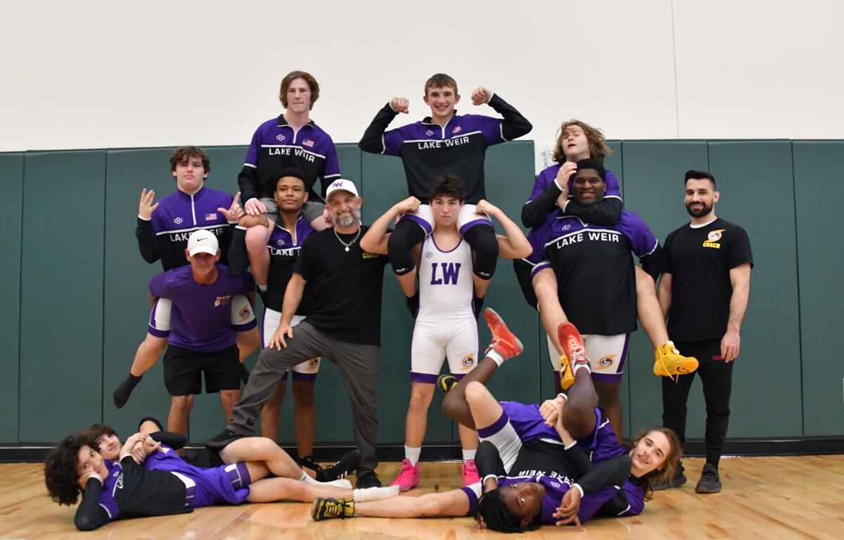 Lake Weir High School wrestlers strike a playful pose after a successful postseason run, including strong finishes at the county and district tournaments. Two athletes advanced to the Florida State Championships in Kissimmee.