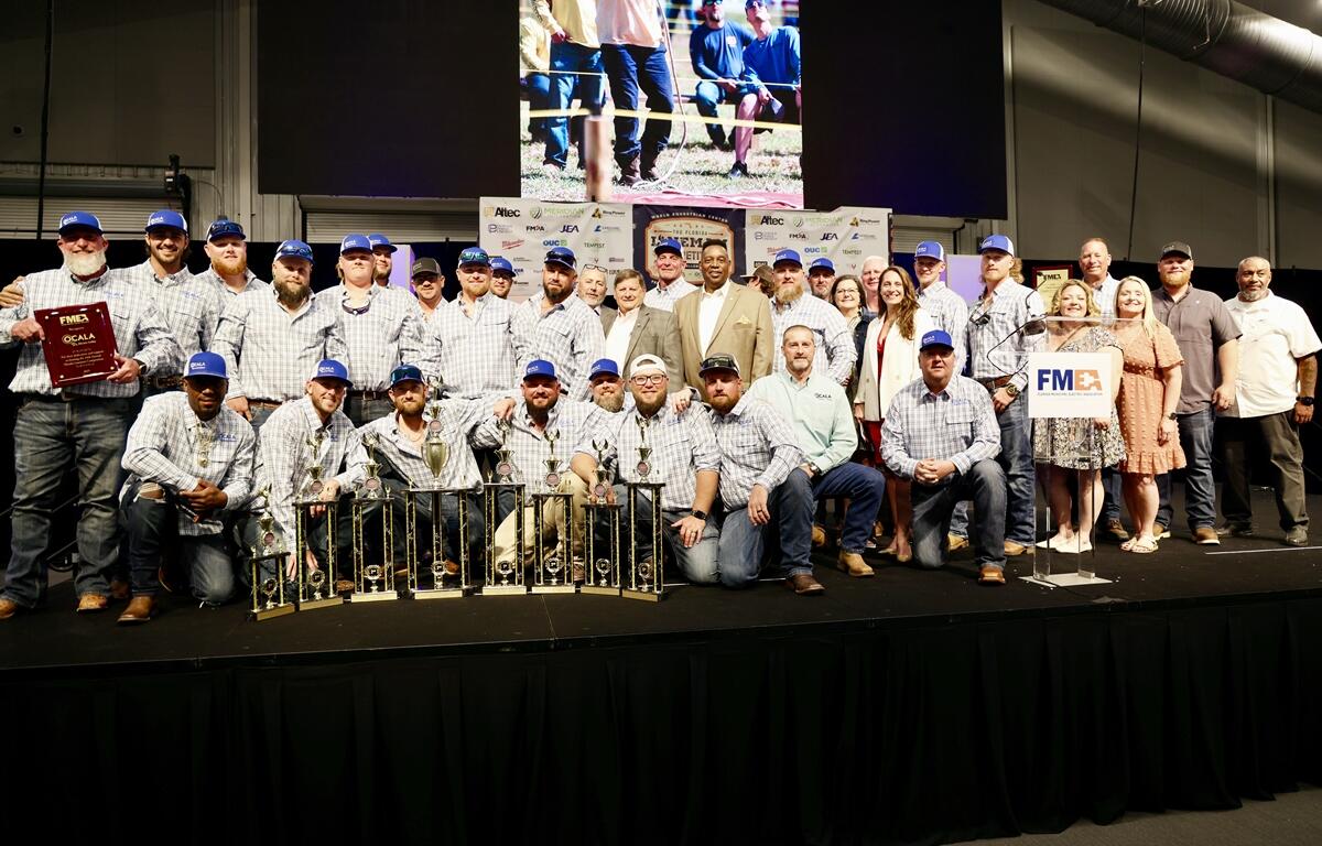 Ocala Electric Utility line workers pose after competing in the 24th annual Florida Lineman Competition at the World Equestrian Center in Ocala, Fla., on March 1, 2025. The team earned multiple top awards for their skill, safety, and teamwork.