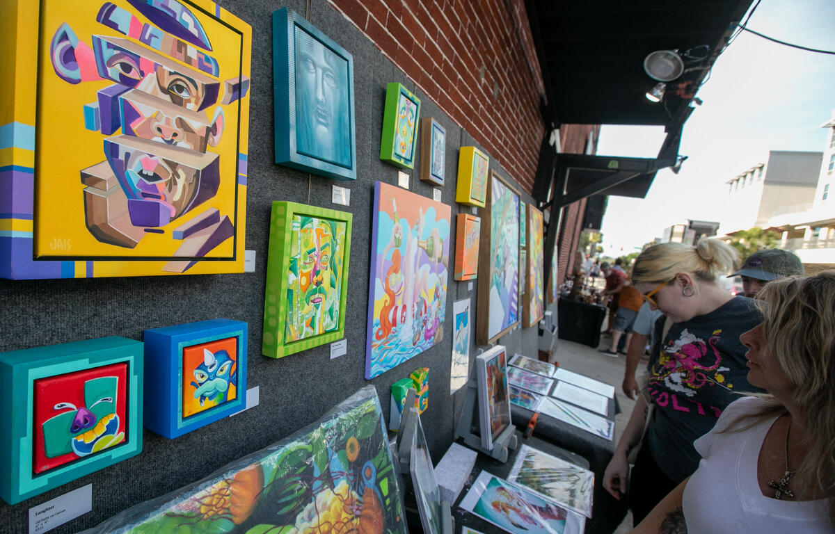 Visitors check out Artist Justin Alsedek work downtown during First Friday Art Walk in Ocala, FL on Friday, April 4, 2025.