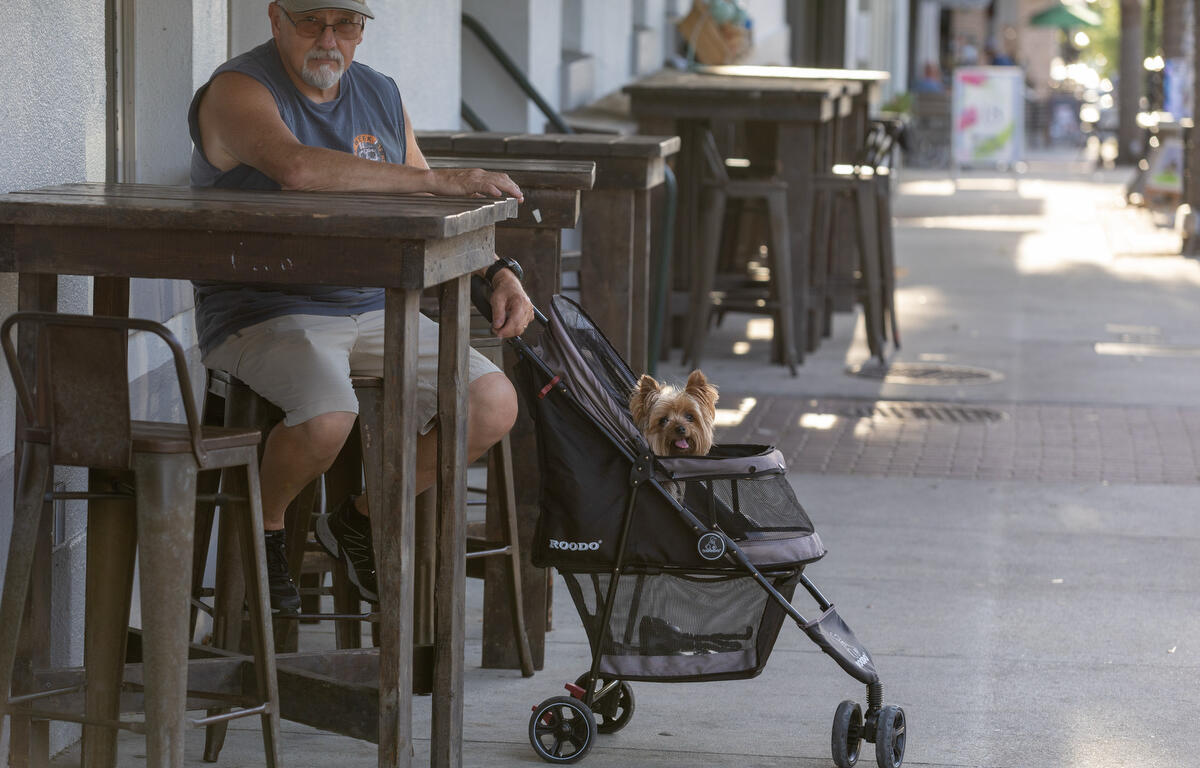Stan Wolf and Bugs wait at the Lodge downtown during First Friday Art Walk in Ocala, FL on Friday, April 4, 2025.