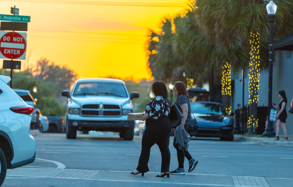 Visitors cross Broadway during First Friday Art Walk in downtown Ocala, FL on Friday, April 4, 2025.