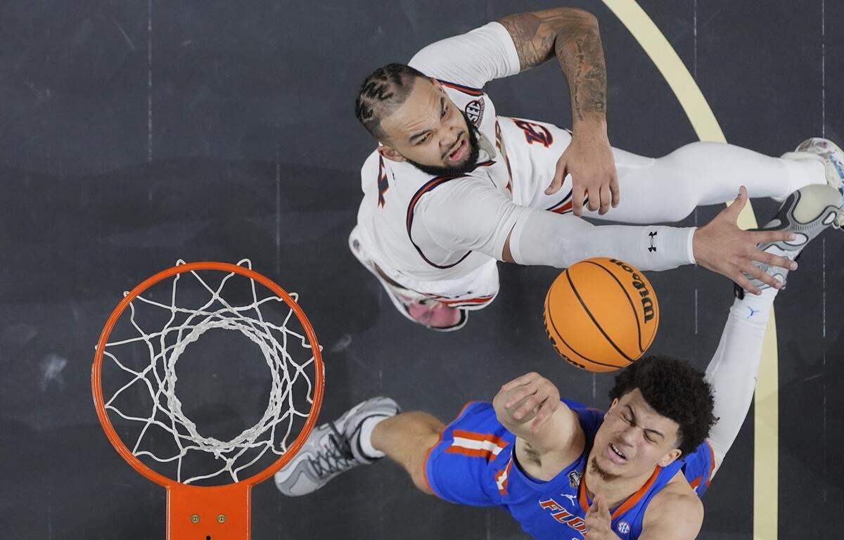 Florida's Walter Clayton Jr. (1) goes up for a shot as Auburn's Johni Broome defends during the second half in the national semifinals at the Final Four of the NCAA college basketball tournament, Saturday, April 5, 2025, in San Antonio.
