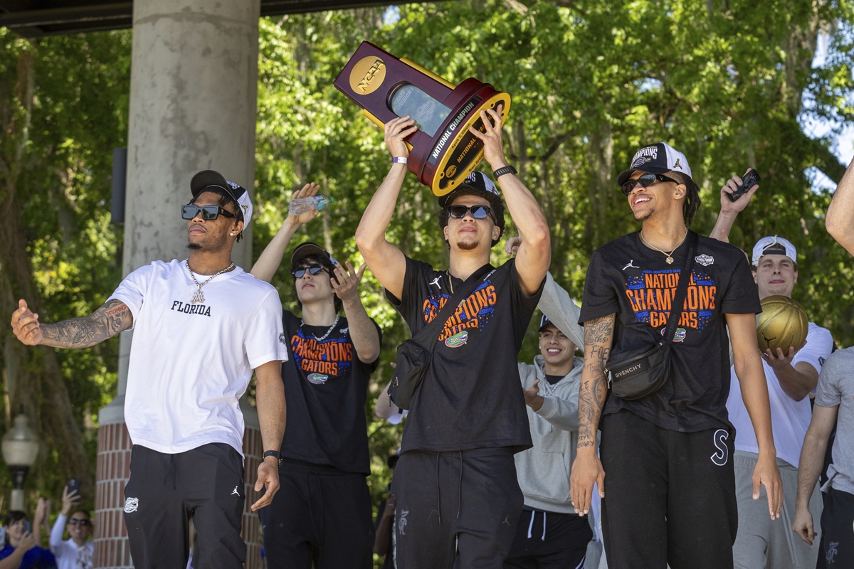 Florida guard Walter Clayton Jr. holds up the trophy as the team arrives at the University of Florida after winning the NCAA national basketball championship, Tuesday, April 8, 2025, in Gainesville, FL.
