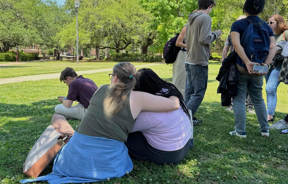 People comfort each other on Florida State University’s campus in Tallahassee, where law enforcement responded to a reported active shooter incident Thursday, April 17, 2025. Courtesy: Kate Payne/AP Photo