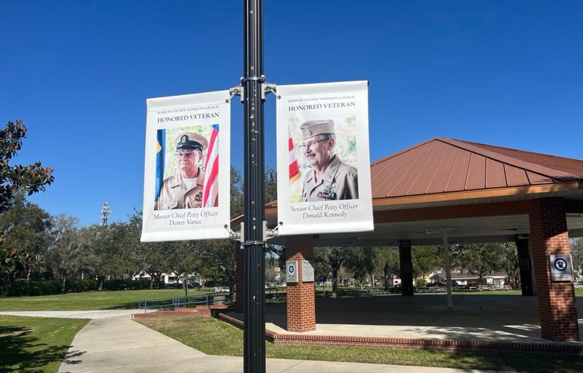 Banners honoring Master Chief Petty Officer Dexter Vance and Senior Chief Petty Officer Donald Kennedy are displayed at the Ocala/Marion County Veterans Memorial Park.