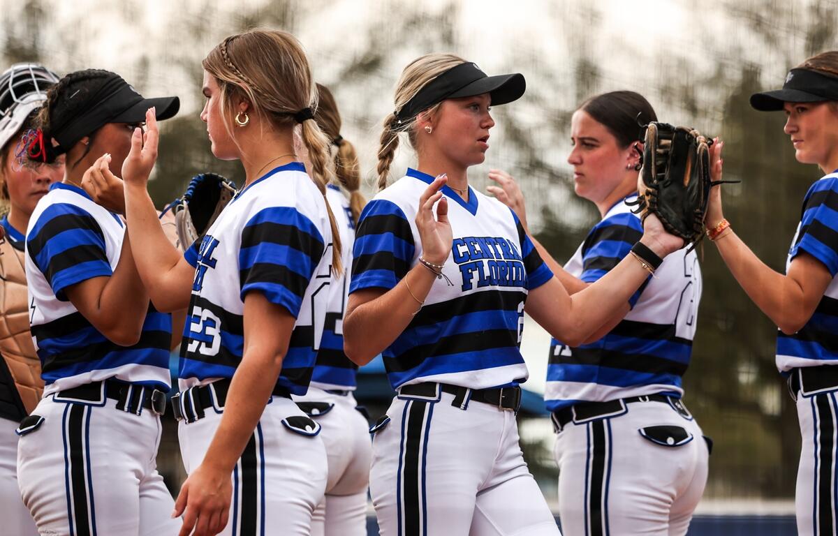 College of Central Florida players celebrate between innings during a recent softball game. The Patriots swept St. Petersburg College on Tuesday with wins of 7-6 and 13-6.