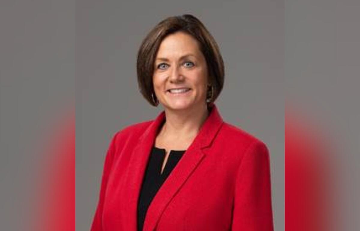 Dr. Danielle Brewer wearing a red blazer and smiling in a professional headshot.