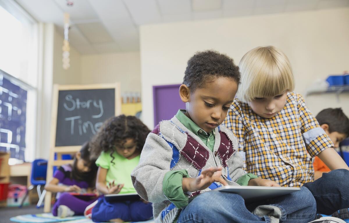 Children participate in a classroom activity during story time.