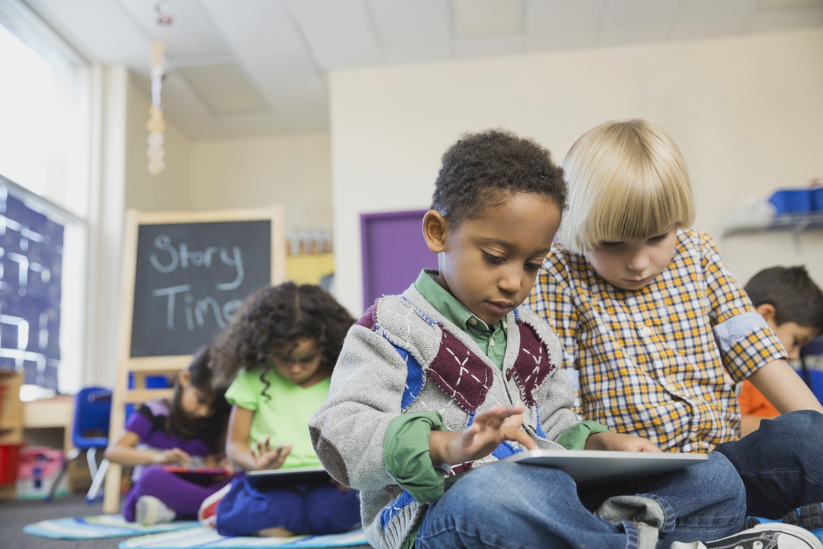Children participate in a classroom activity during story time.