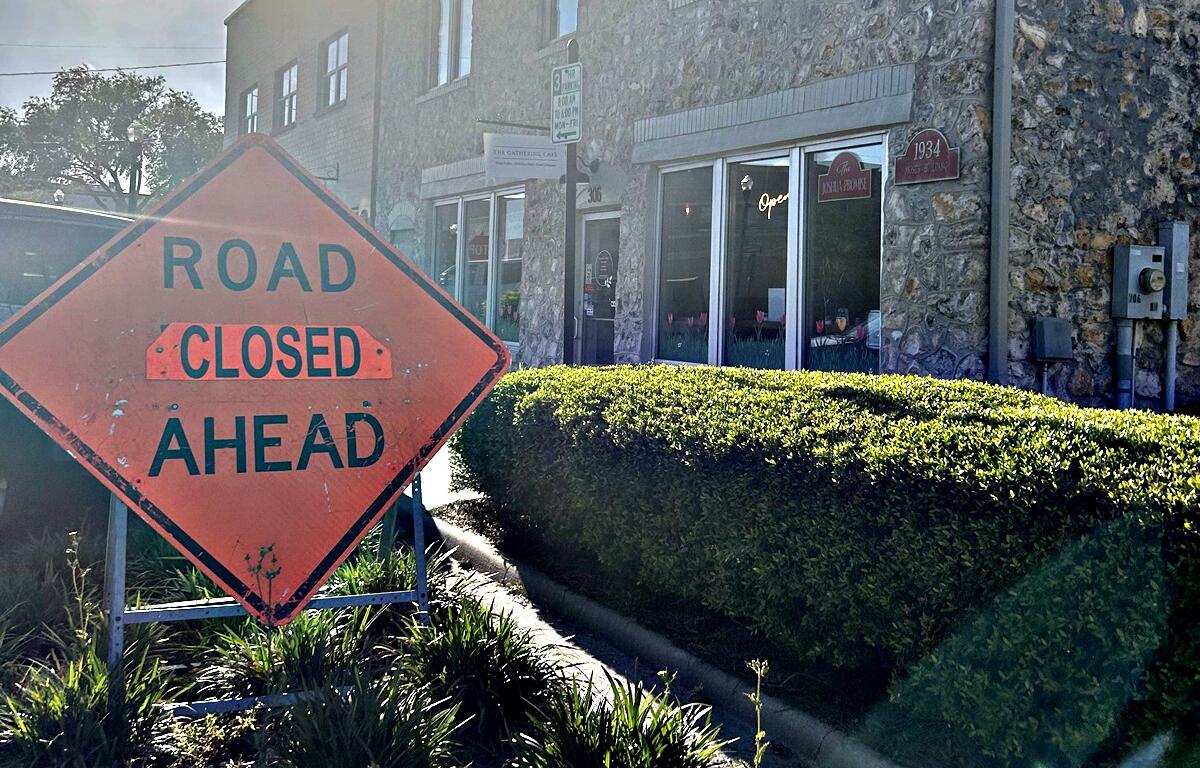 A “Road Closed Ahead” sign stands in front of The Gathering Café on Broadway Street in downtown Ocala, where ongoing construction is impacting access and foot traffic.