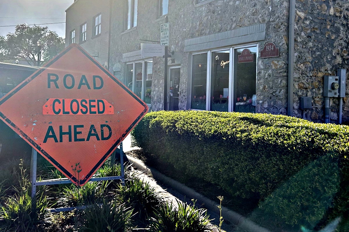 A “Road Closed Ahead” sign stands in front of The Gathering Café on Broadway Street in downtown Ocala, where ongoing construction is impacting access and foot traffic.
