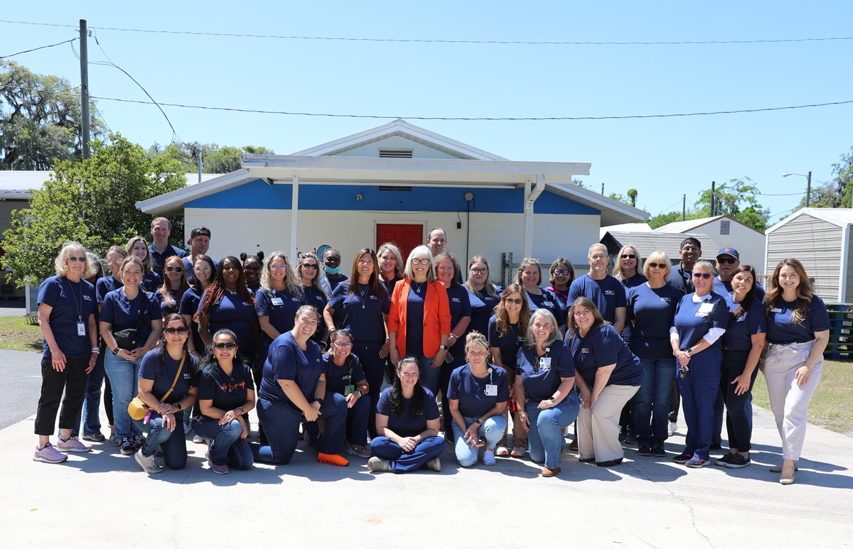 HCA Florida Healthcare staff and volunteers gather outside Interfaith Emergency Services in Ocala after a day of community service on April 17, 2025.