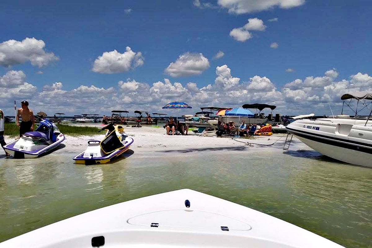 Families and friends anchor at Lake Weir to enjoy the warm weather, cool water, and a perfect spring day in Marion County.