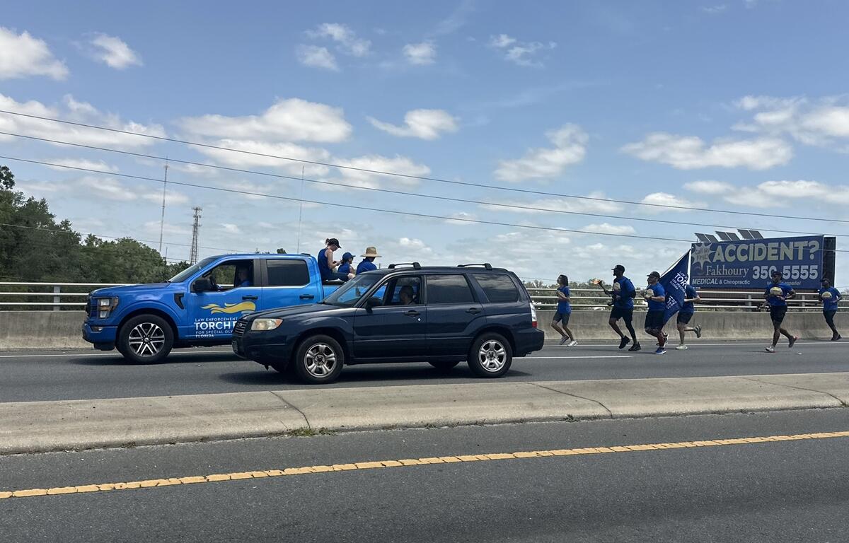 Law enforcement officers and Special Olympics supporters run through Ocala on Thursday during the annual Law Enforcement Torch Run, which raises awareness and funds for Special Olympics.