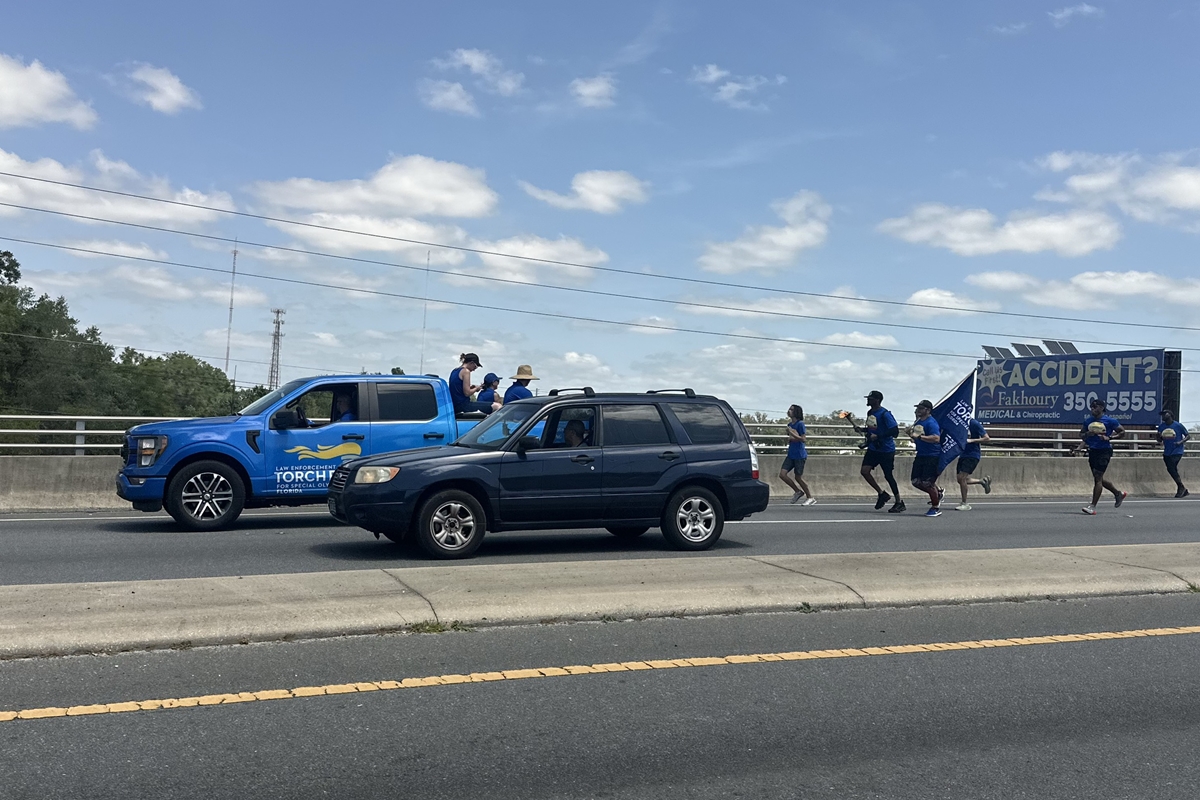 Law enforcement officers and Special Olympics supporters run through Ocala on Thursday during the annual Law Enforcement Torch Run, which raises awareness and funds for Special Olympics.