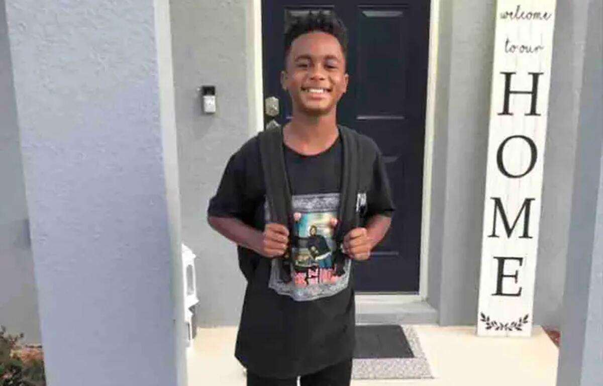 Louis “LJ” Johnson III, 10, is seen smiling in a family photo taken outside his home. His parents have filed a wrongful death lawsuit against the Marion County School Board, alleging teacher-led bullying led to his 2023 suicide.