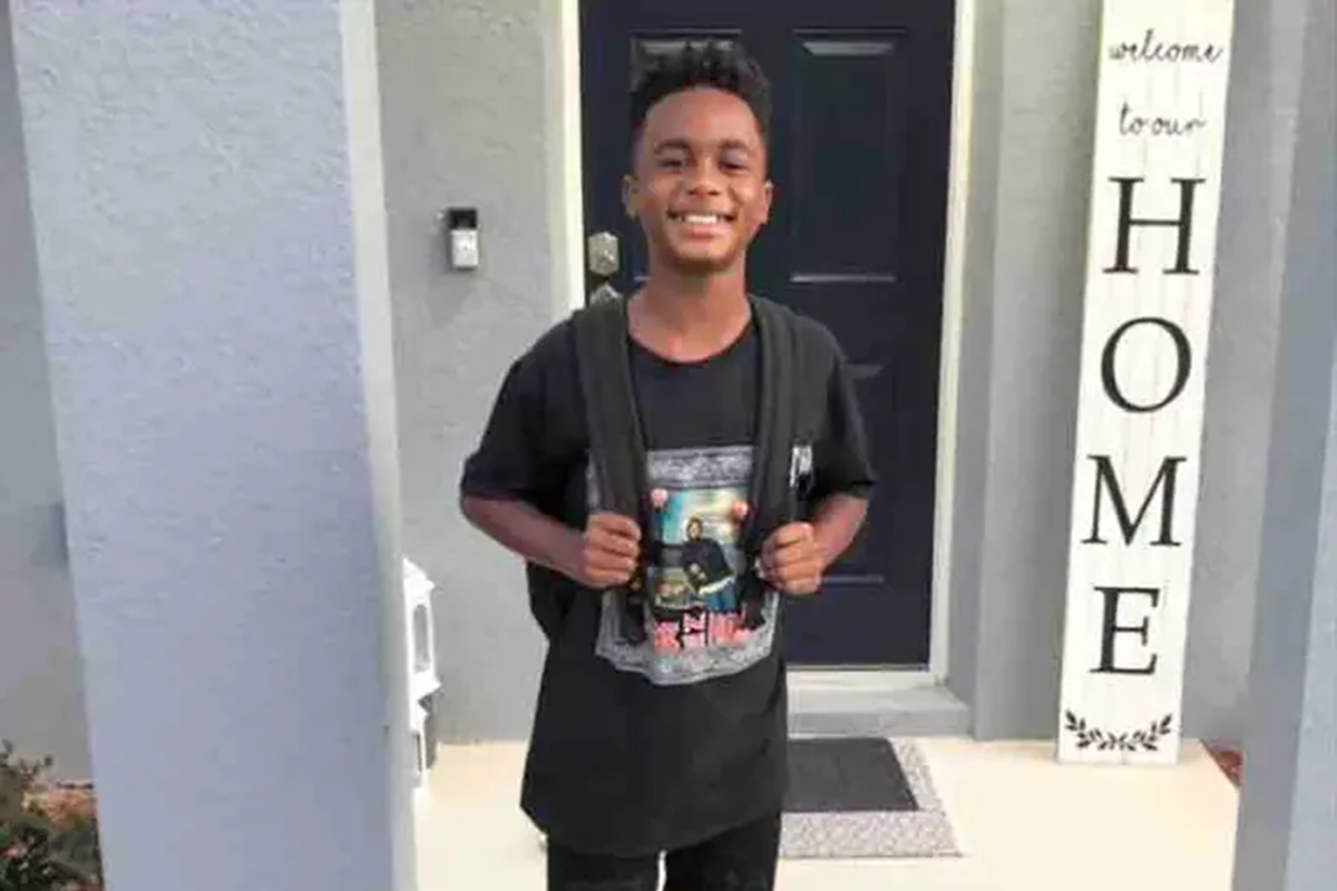 Louis “LJ” Johnson III, 10, is seen smiling in a family photo taken outside his home. His parents have filed a wrongful death lawsuit against the Marion County School Board, alleging teacher-led bullying led to his 2023 suicide.