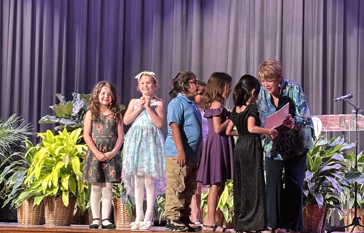 Laurie Zink, Ocala Civic Theatre, Development and Community Outreach Director, congratulates students. Courtesy: Kathy Dugan/352today