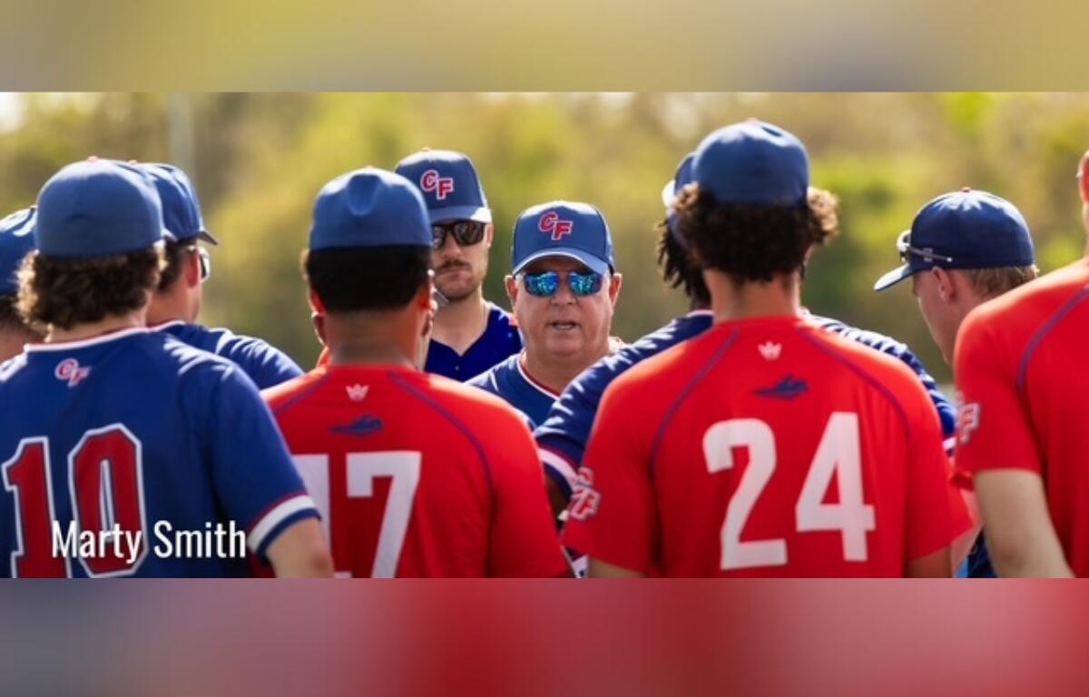 College of Central Florida head coach Marty Smith talks with players during a team huddle before a game in Ocala.