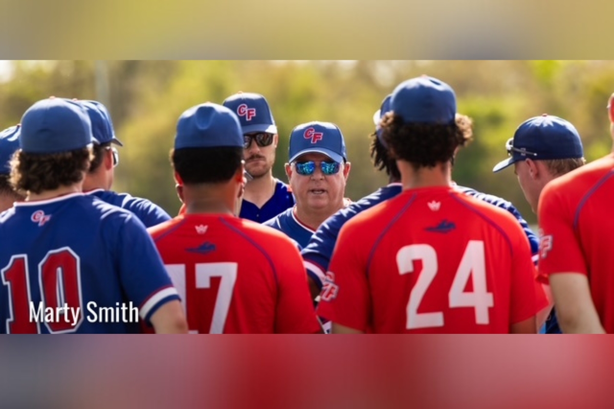 College of Central Florida head coach Marty Smith talks with players during a team huddle before a game in Ocala.