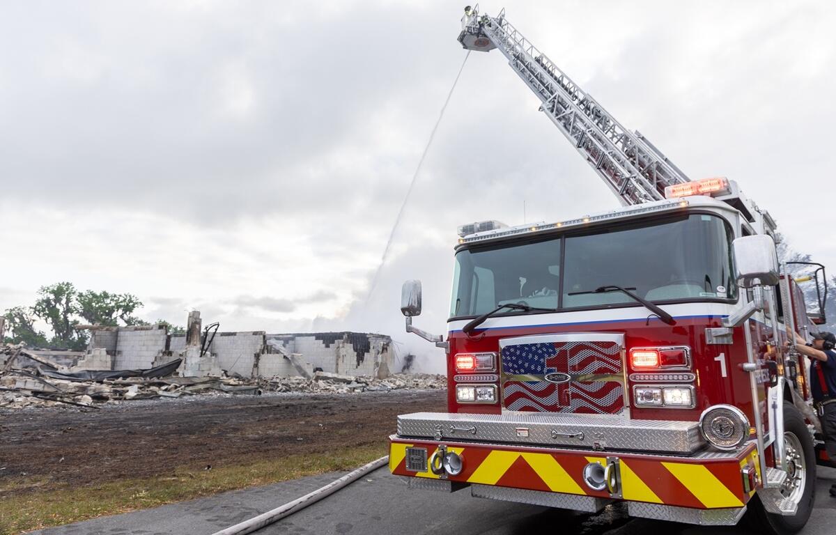 A Marion County Fire Rescue engine sprays water over the smoldering remains of a barn in Reddick, Fla., on Monday, April 8, 2024. The early morning fire destroyed the structure and killed 21 horses. The cause is under investigation.