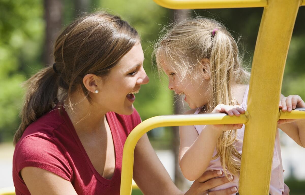 A mother and daughter enjoy time at the playground - one of the many community spaces impacted by long-term planning between local governments and schools.