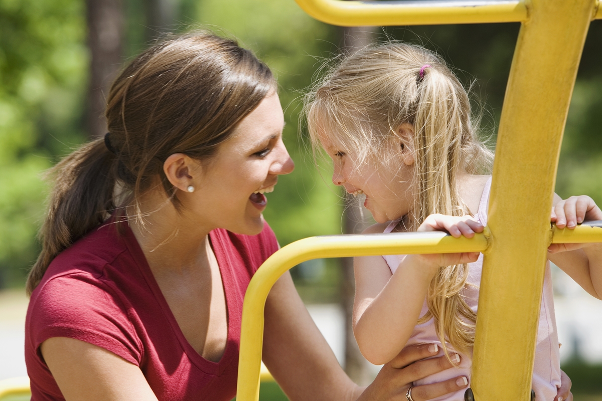 A mother and daughter enjoy time at the playground - one of the many community spaces impacted by long-term planning between local governments and schools.