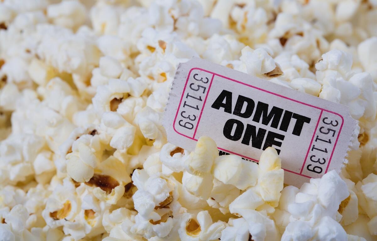 A single Admit One ticket and popcorn