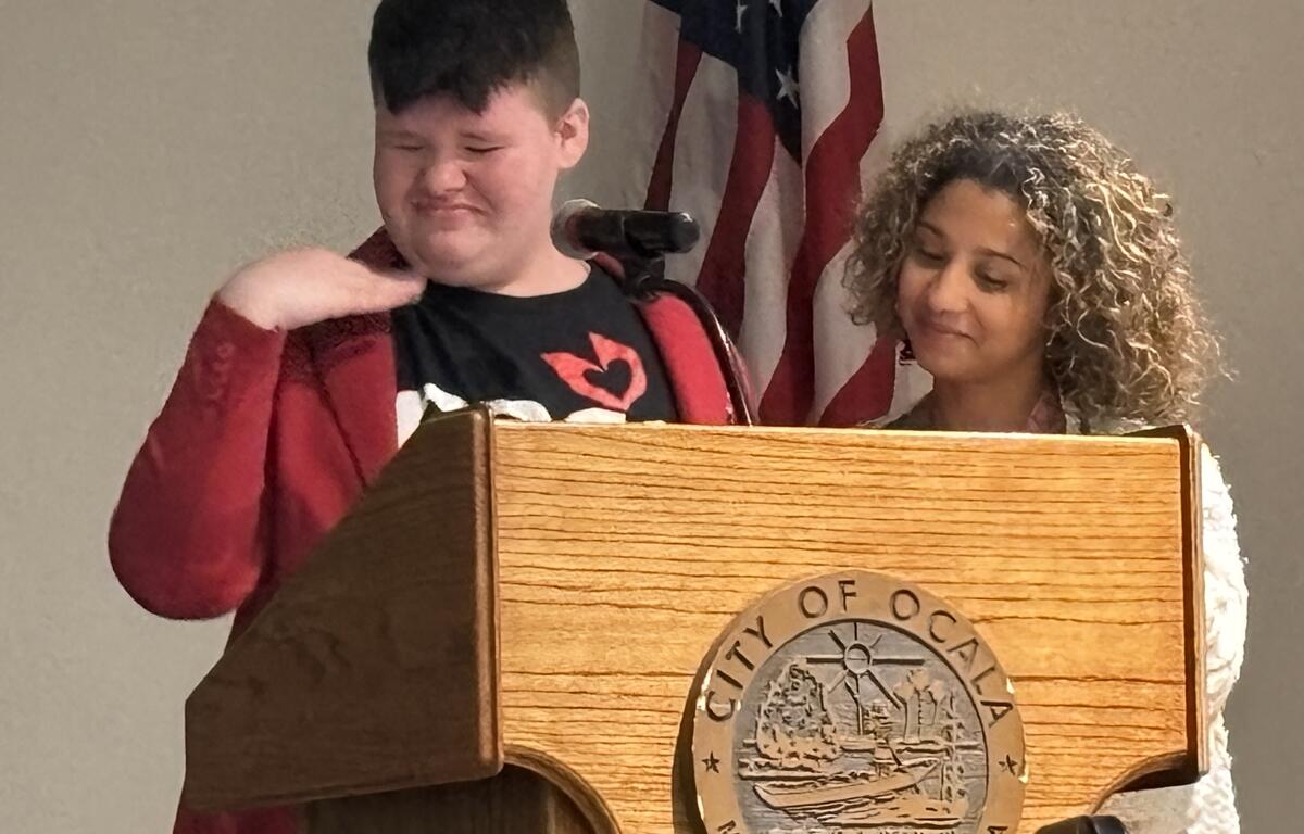 Maggie Smallwood shared her struggles, including suicide attempts in an emotional speech. Her teacher, Hillary Cabezudo comforts her.