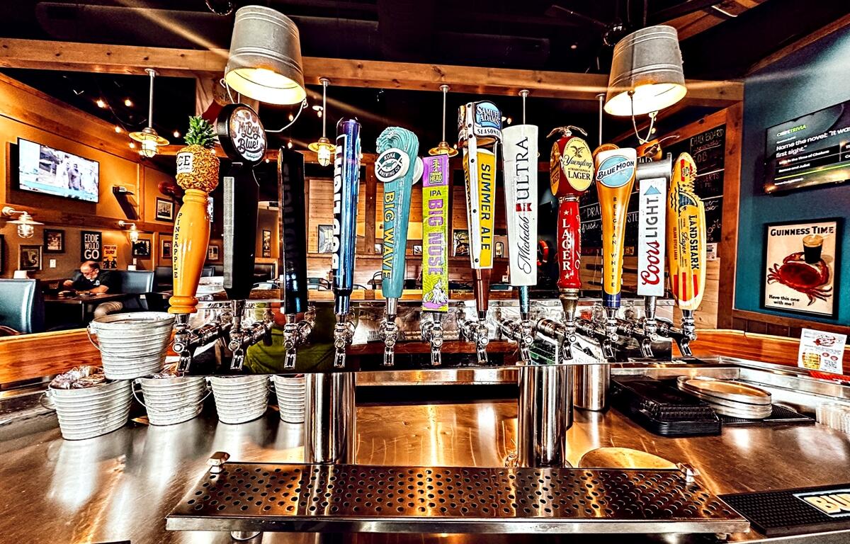 Beer taps line the bar at Shuckin' Shack Oyster Bar in Ocala, FL, offering a wide selection of local and national brews just in time for National Beer Day on April 7, 2025.